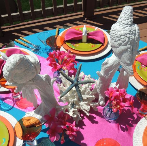 Tablescapes at Table Twenty-One: Mid-priced tropical-themed centerpiece with white parrots from Z Gallerie, white coral, blue starfish and fuchsia plumeria