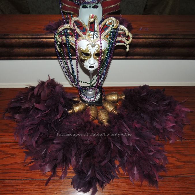 Tablescapes at Table Twenty-One, www.tabletwentyone.wordpress.com: Celebrate Mardi Gras! - Buffet mask surrounded in feathered tassels