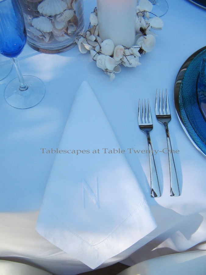 Tablescapes at Table Twenty-One, www.tabletwentyone.wordpress.com, Ocean Blue – Starfish & Seashells:  White cotton napkin with initial
