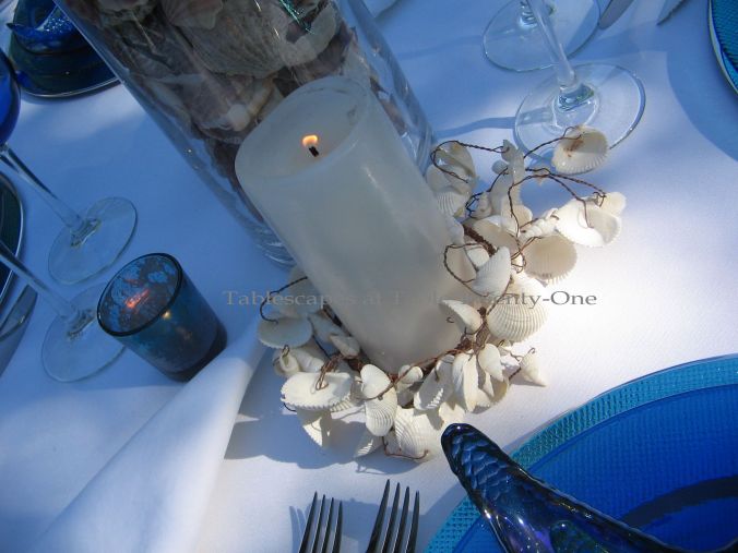 Tablescapes at Table Twenty-One, www.tabletwentyone.wordpress.com, Ocean Blue – Starfish & Seashells:  white pillar candle with Z Gallerie seashell candle ring