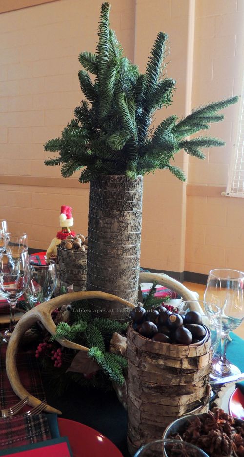 Alycia Nichols, Tablescapes at Table Twenty-One, www.tabletwentyone.wordpress.com, “Christmas in the Woods”: Centerpiece with bark-covered vase, antlers, woodland creatures