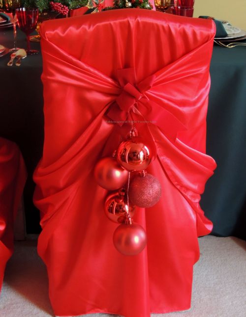 Alycia Nichols, Tablescapes at Table Twenty-One, www.tabletwentyone.wordpress.com, “Old-Fashioned Red & Green Christmas”:  Banquet chair with red decor