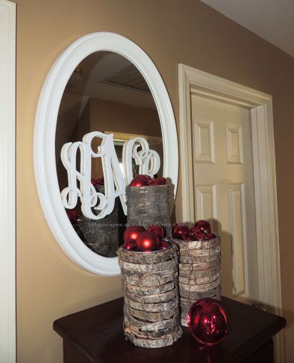 Alycia Nichols, Tablescapes at Table Twenty-One, www.tabletwentyone.wordpress.com, ”Timberland Christmas – 2014 Christmas Décor: Red Christmas ornaments in bark-wrapped cylinders, wood monogrammed mirror