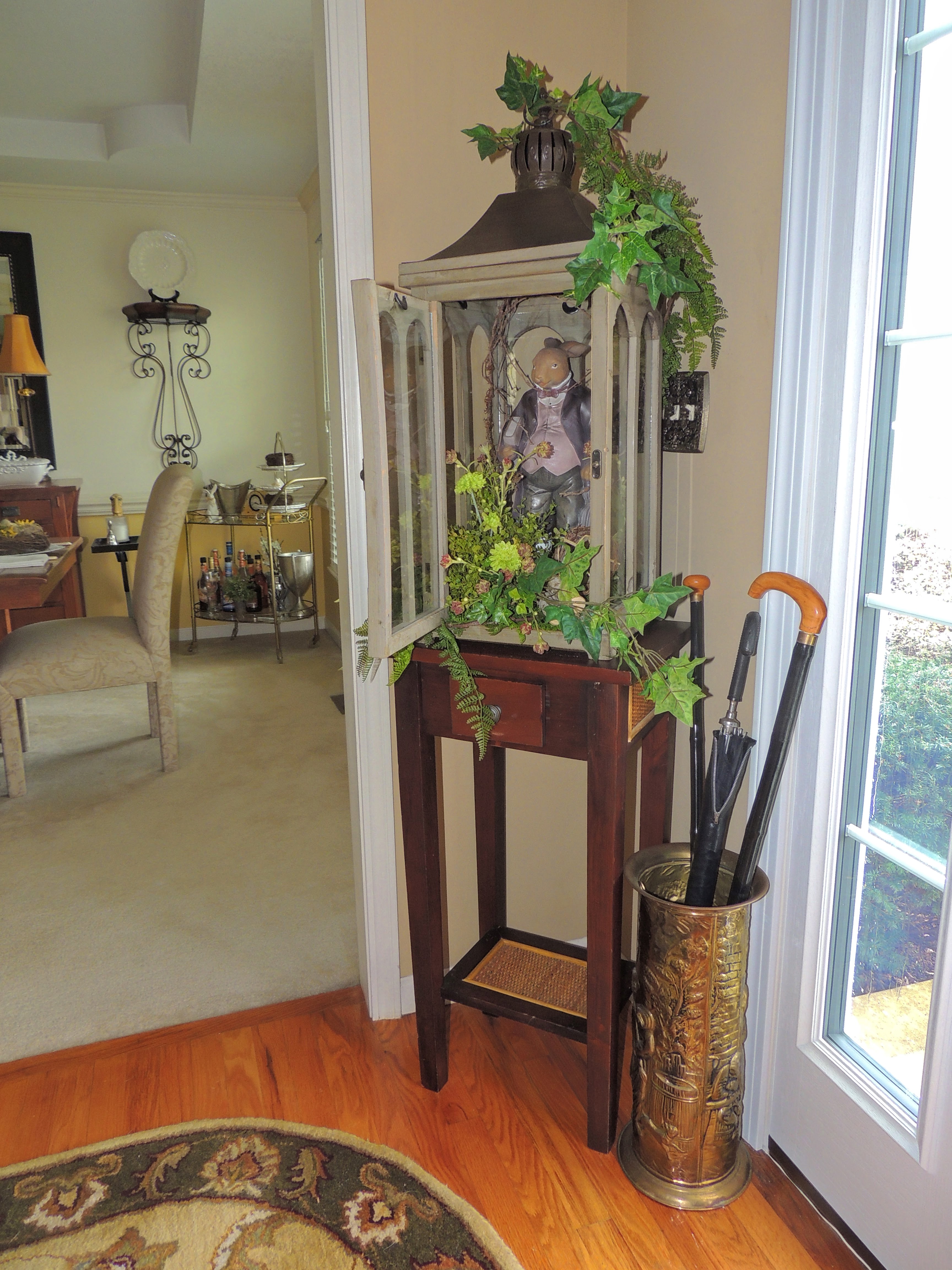 Easter bunny in wood lantern lavished with greenery &amp; flowers