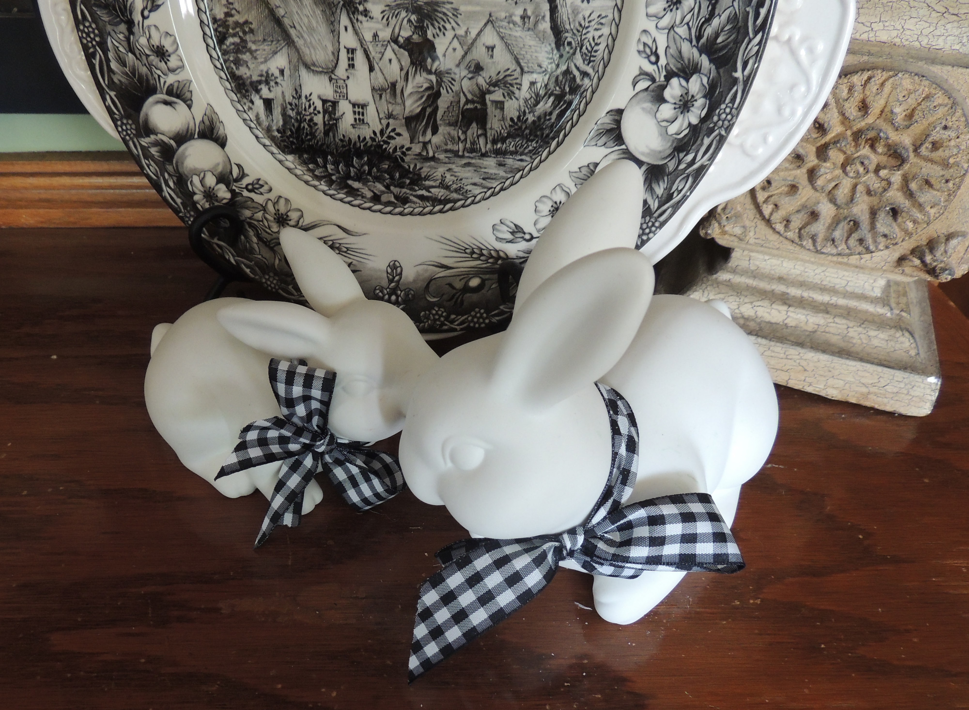 White bunnies with black &amp; white gingham check neck bows in front of black &amp; white transferware. www.tabletwentyone.wordpress.com